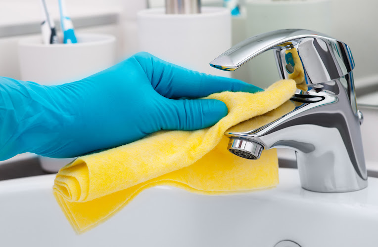 Woman doing chores in bathroom, cleaning tap